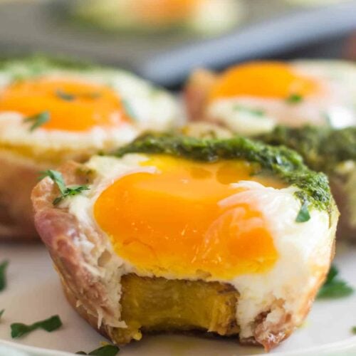 Close up of prosciutto egg cup with a bit taken out of it