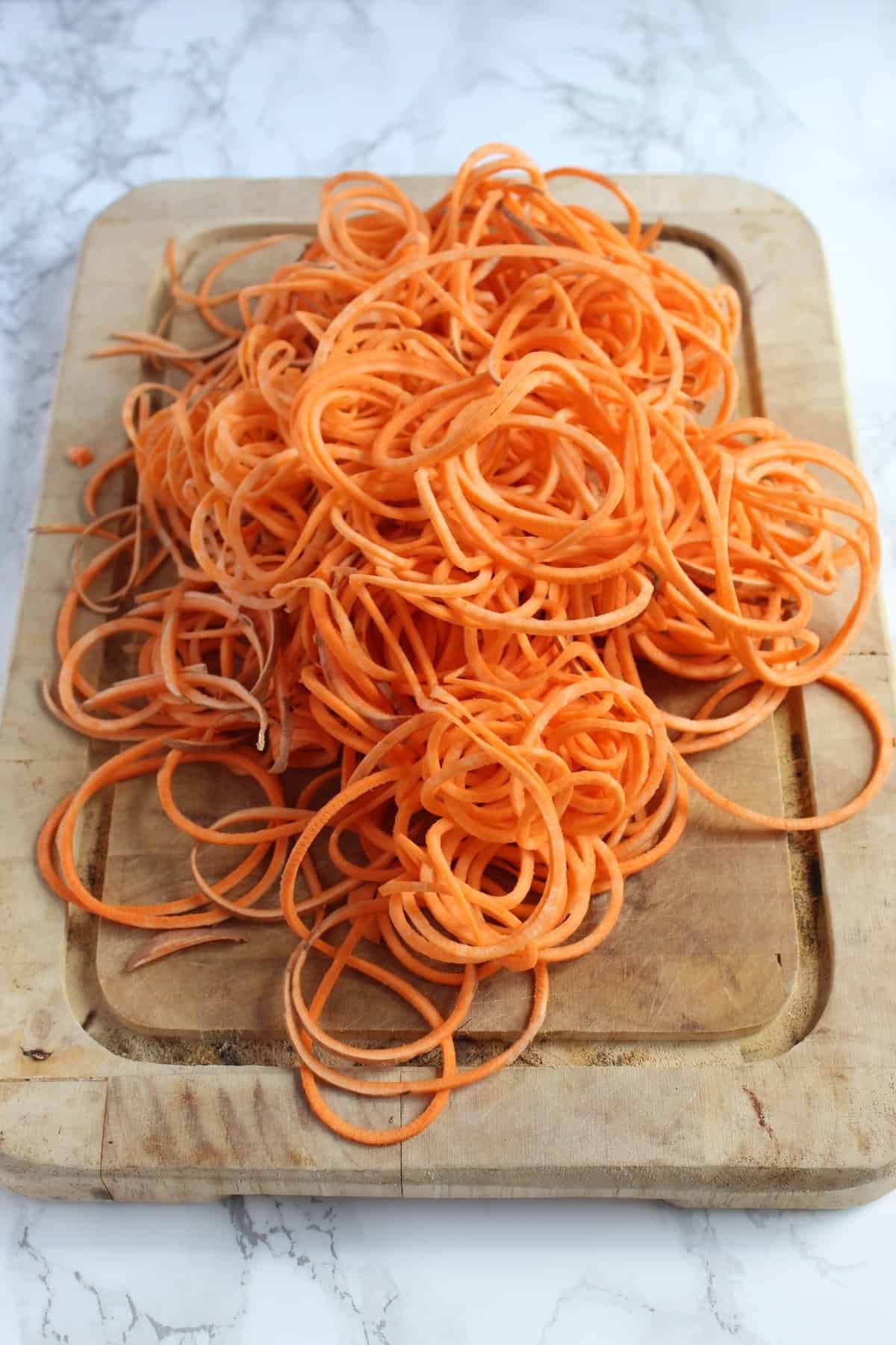 This Sweet Potato Egg in a Hole uses spiralized sweet potatoes as a nest to hold your eggs, making breakfast gluten free, paleo, Whole30, nutritious, & fun!