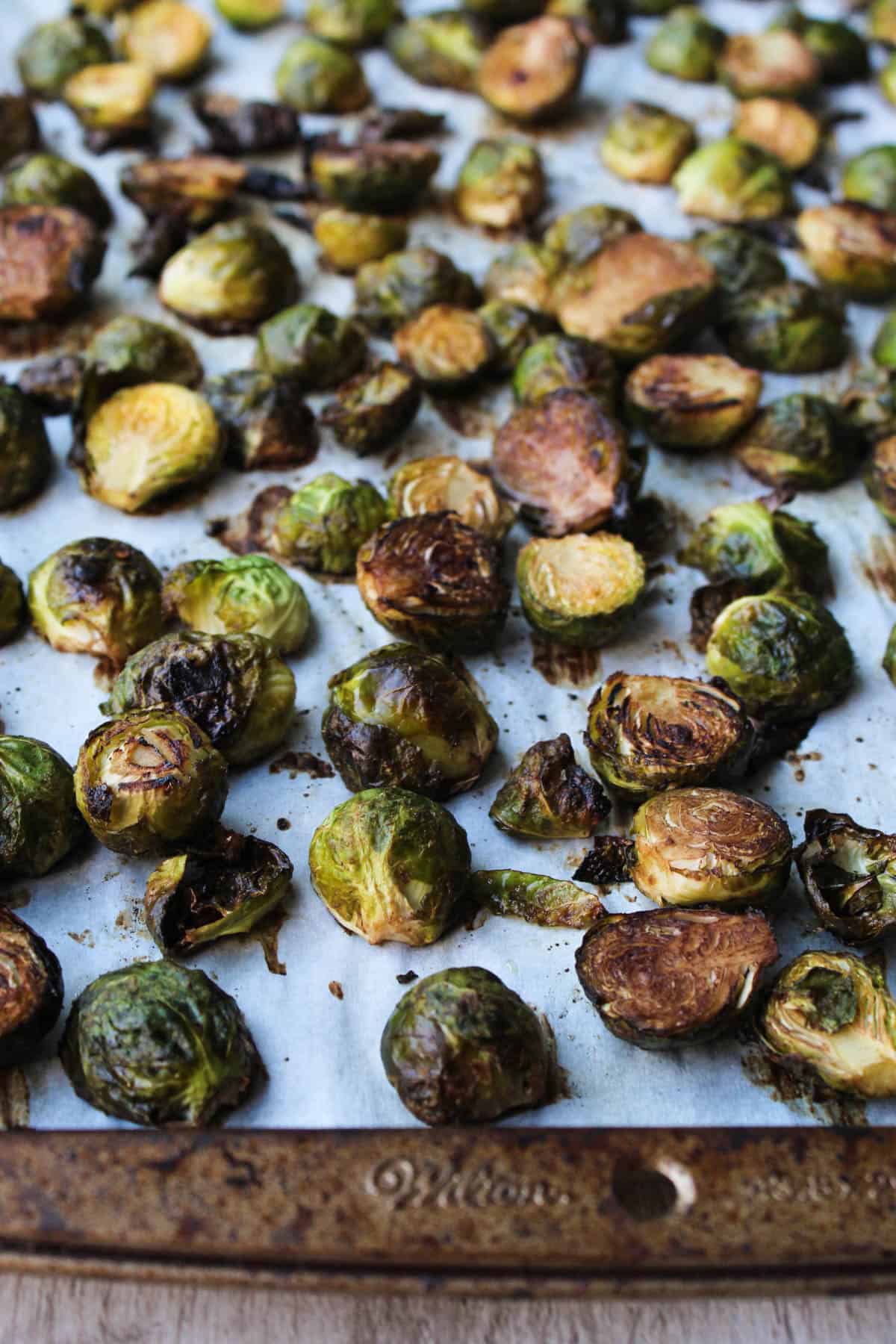 These Ginger & Balsamic Roasted Brussels Sprouts with Pomegranates are an easy & healthy side dish that are just as festive as the holiday season - Eat the Gains