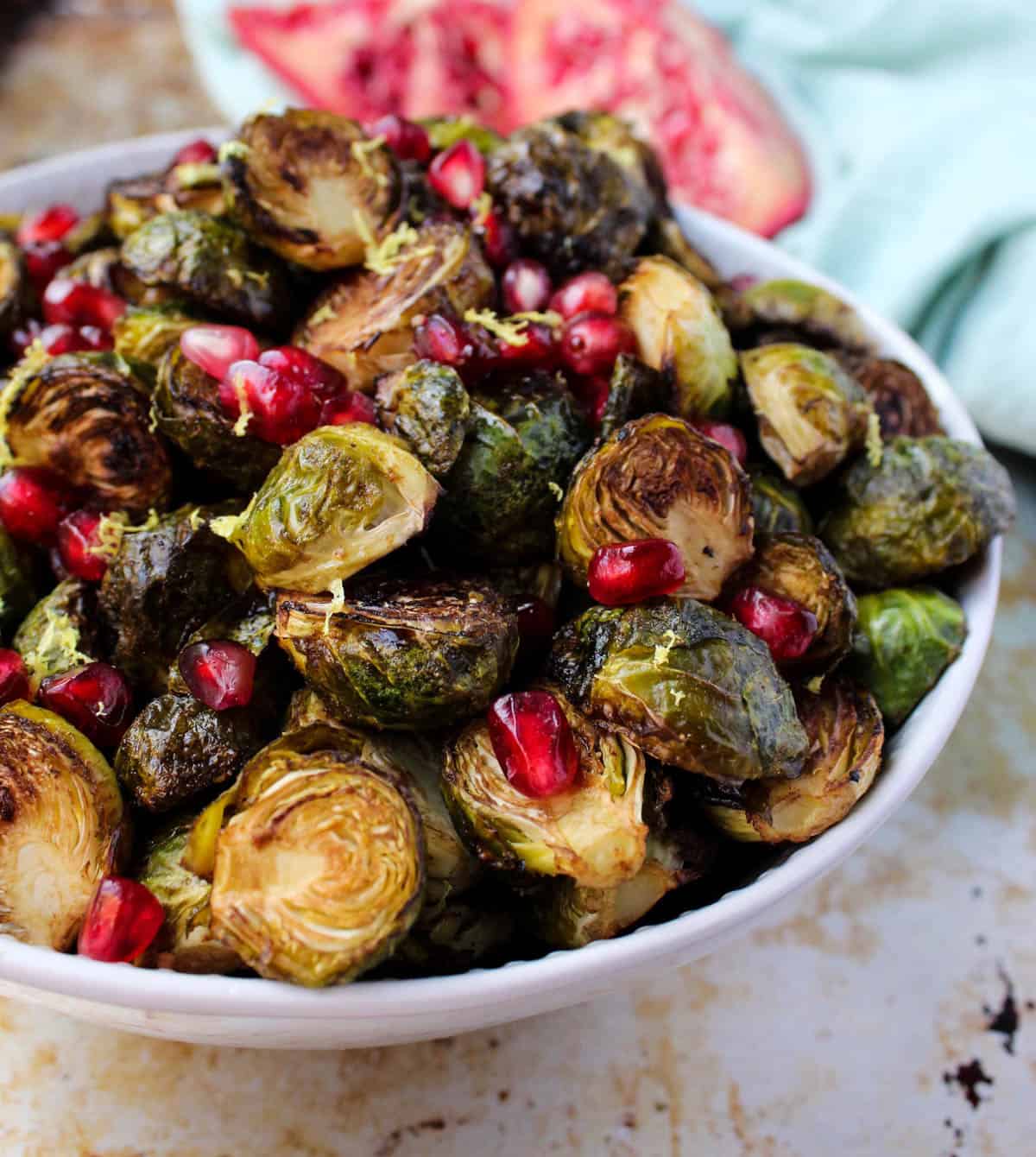 These Ginger & Balsamic Roasted Brussels Sprouts with Pomegranates are an easy & healthy side dish that are just as festive as the holiday season - Eat the Gains