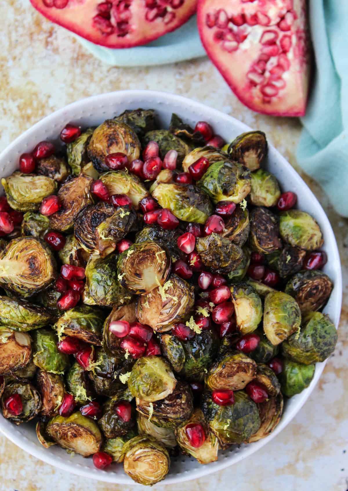 These Ginger & Balsamic Roasted Brussels Sprouts with Pomegranates are an easy & healthy side dish that are just as festive as the holiday season - Eat the Gains