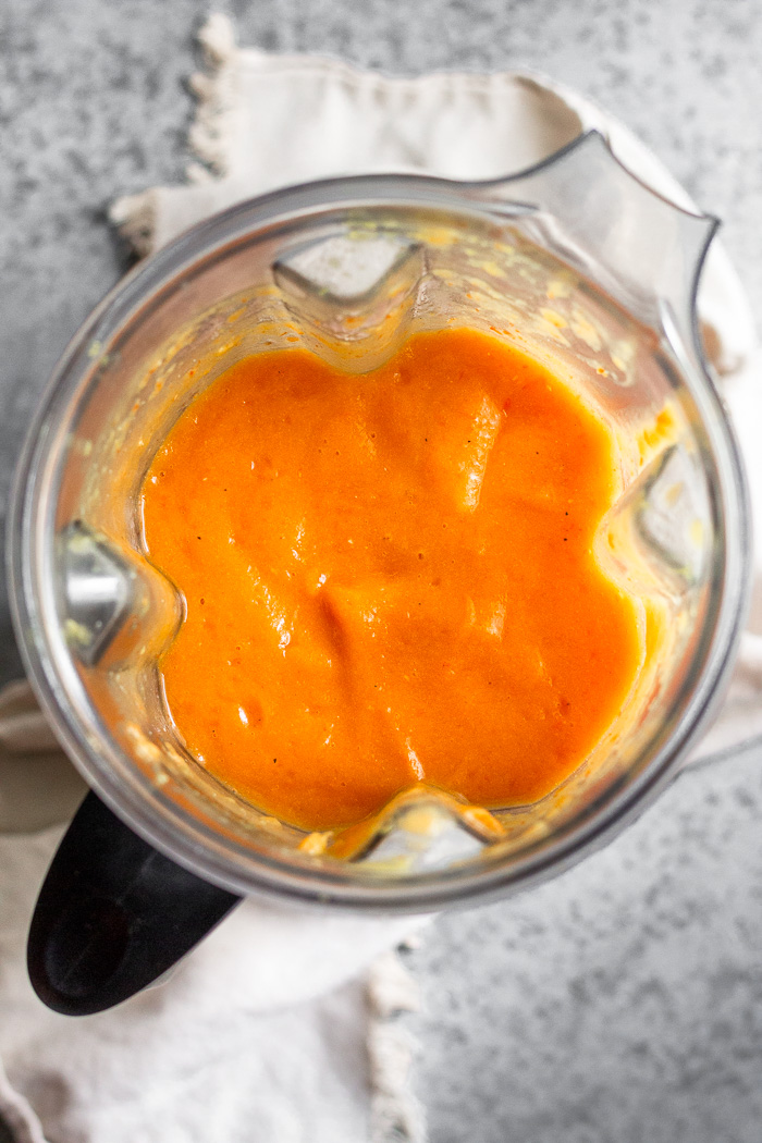 Blender filled with roasted acorn squash soup.
