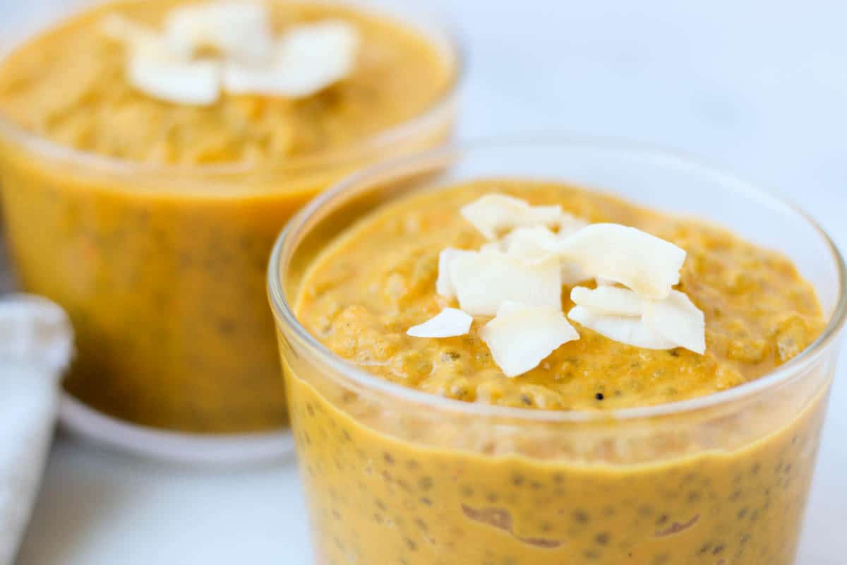 This Carrot Cake Chia Pudding takes the flavors of a classic dessert and turns it into a healthy snack that is paleo, vegan, and dairy & gluten free - Eat the Gains