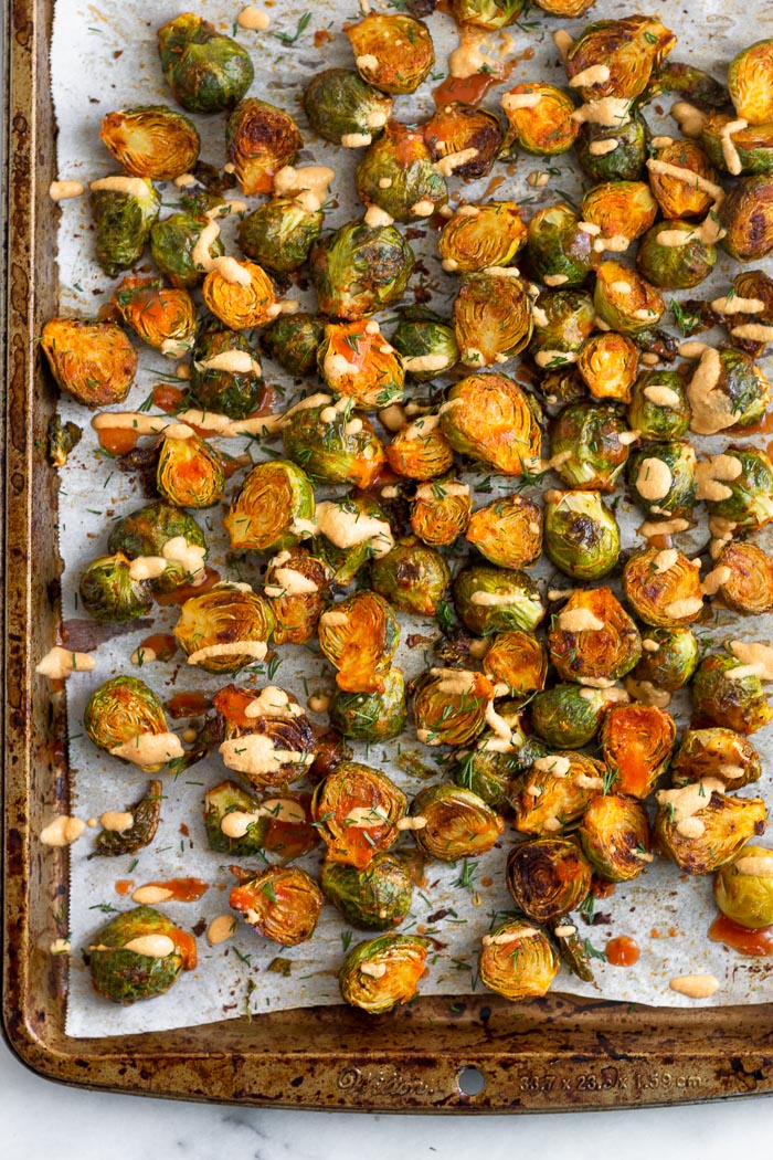 Best sprout recipe topping with fresh dill and cheesy buffalo sauce on a large baking sheet.