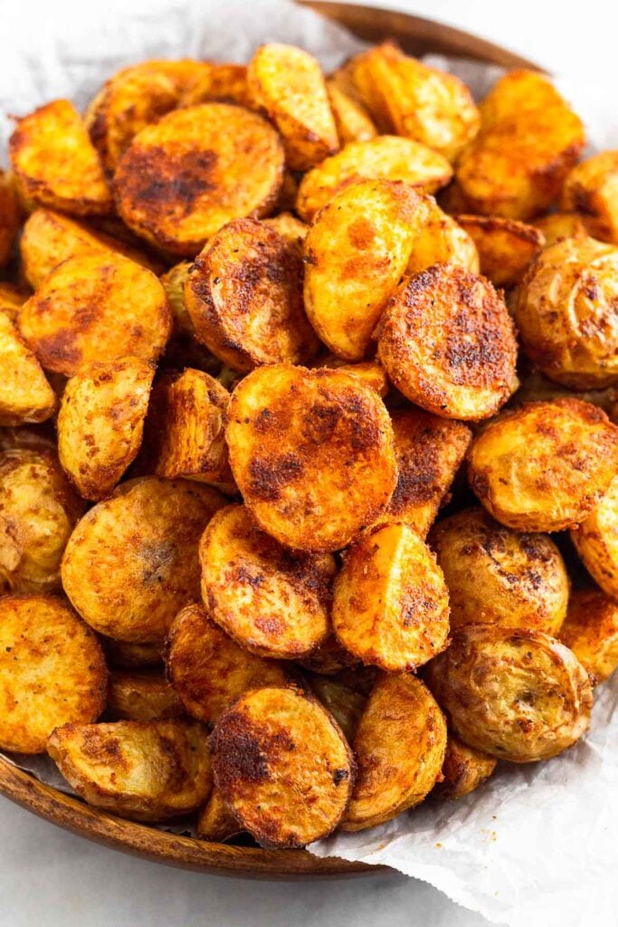 Plate full of breakfast potatoes piled on top of each other.