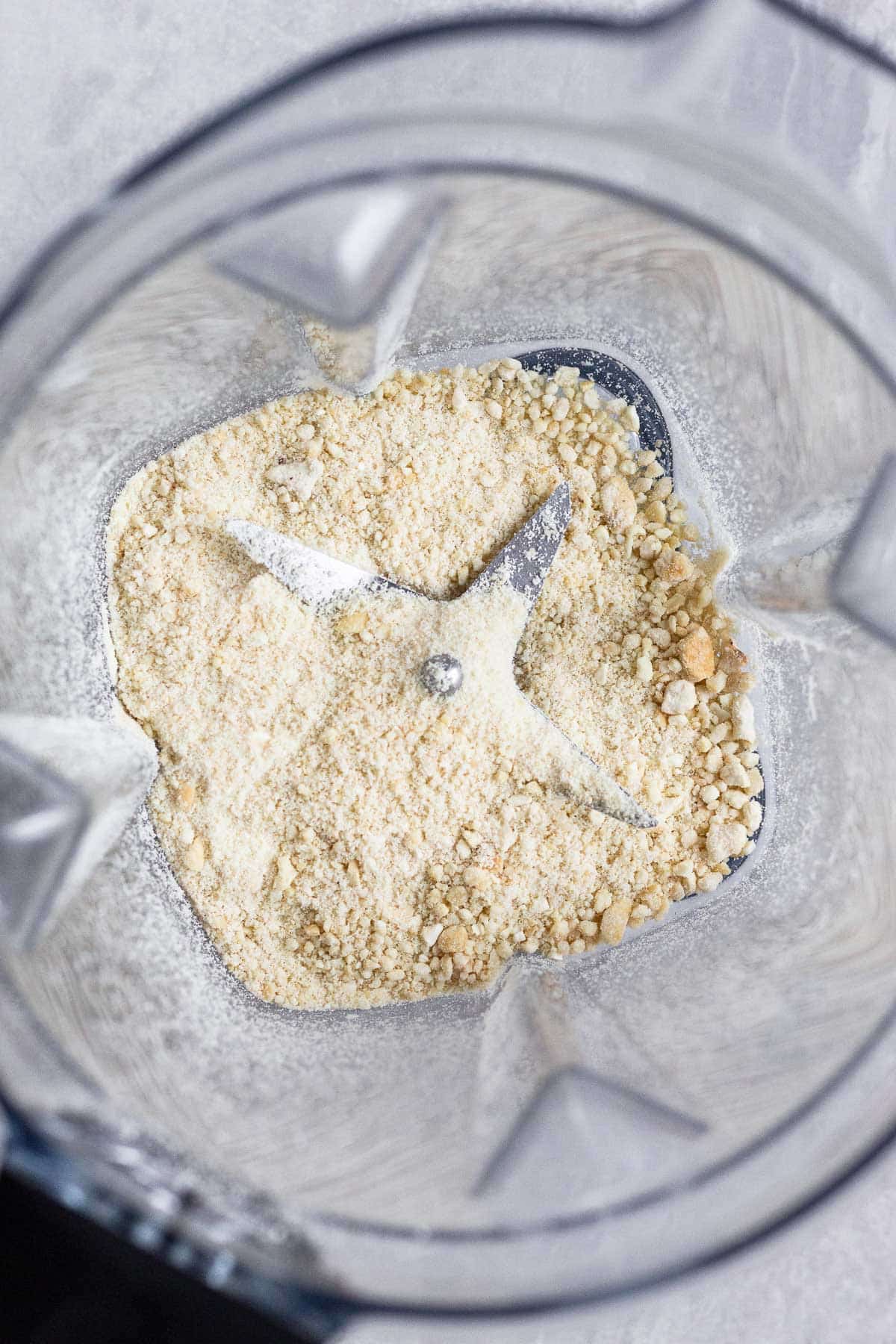 Blender filled with ground up cashews.