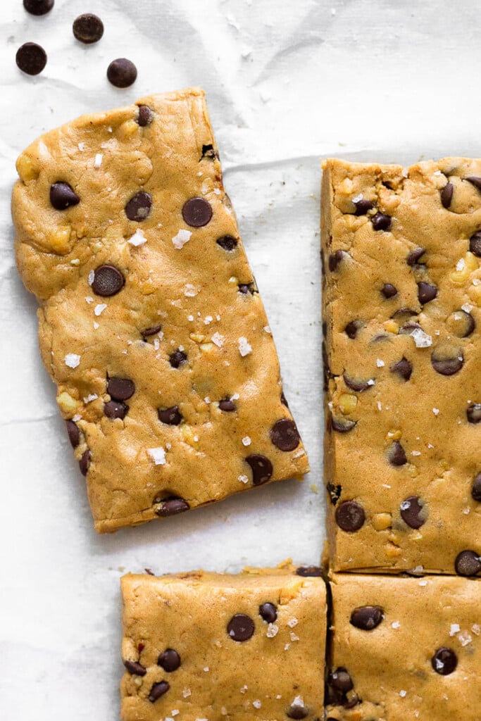 Overhead shot of homemade perfect bars lined up with one slightly pulled apart from the others. A few mini chocolate chips are next to the one pulled away from the rest.