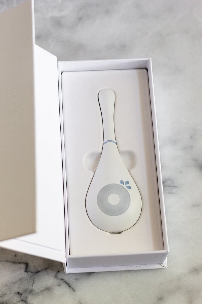 Daysy Fertility Monitor in it's box on a white counter.