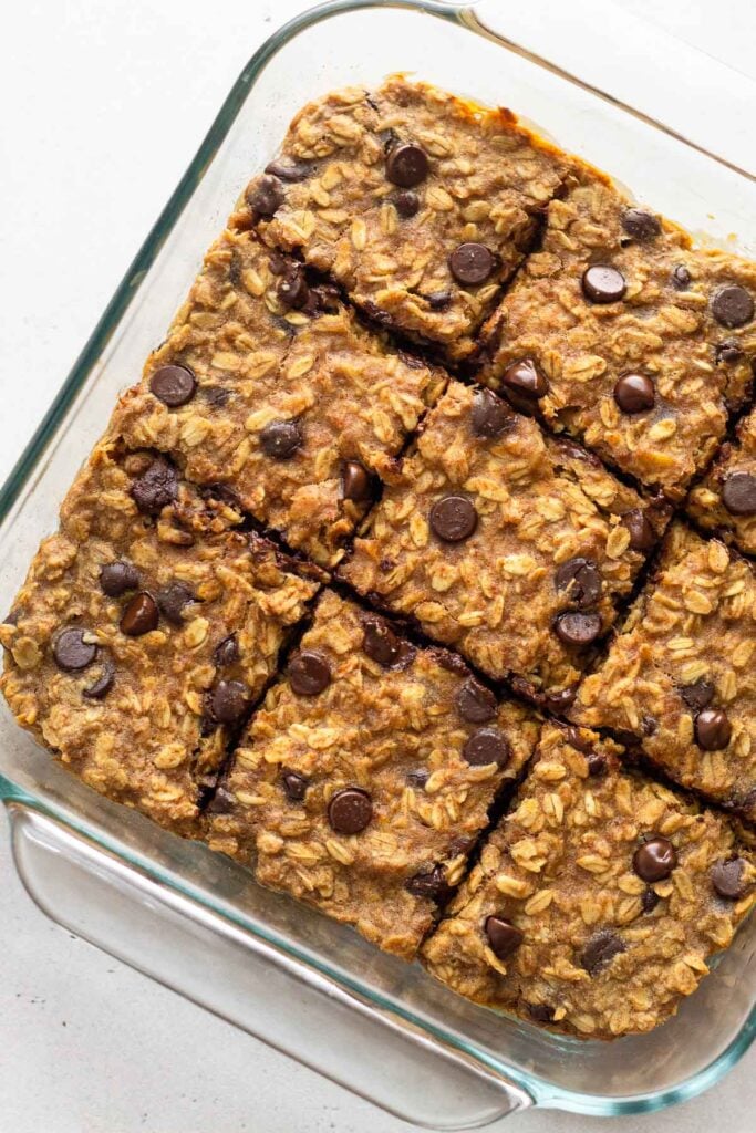 Large pan of healthy oatmeal chocolate chip bars cut into 9 equal-size squares.