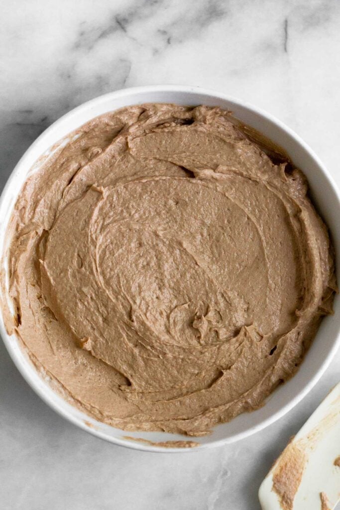 A white bowl filled with mixture of chocolate, peanut butter, and yogurt.