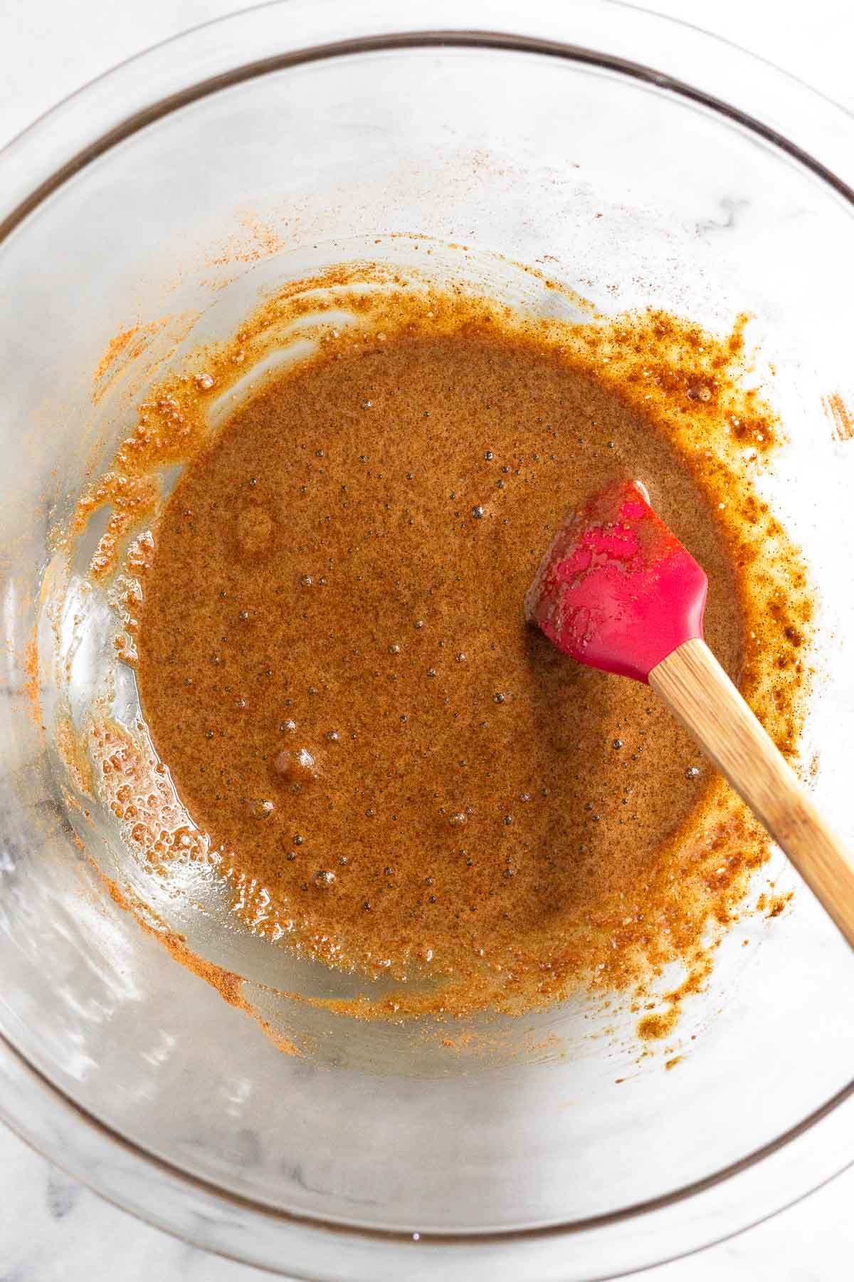 Glass bowl of a mixture of sugar, cinnamon, and egg whites.