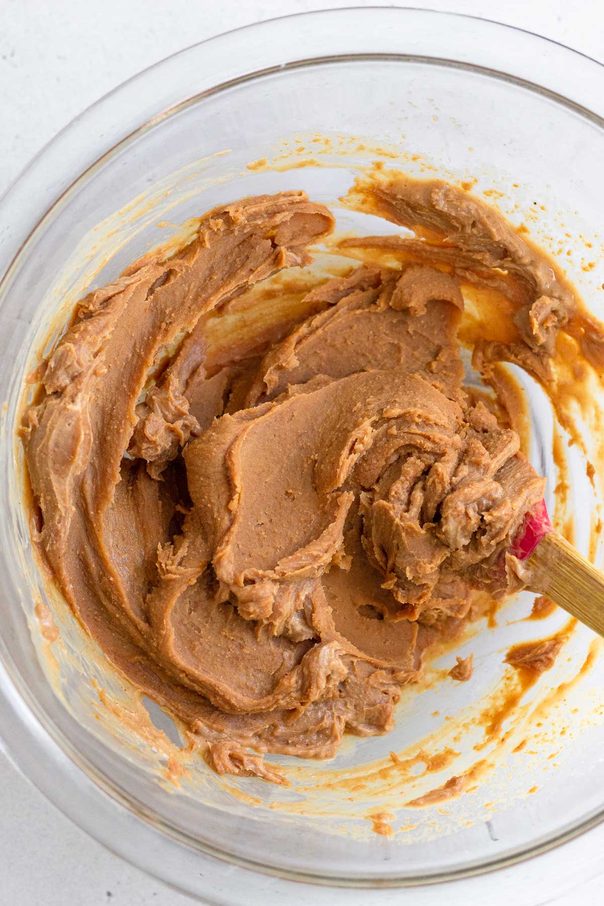 A glass bowl of a mixture of cashew butter.