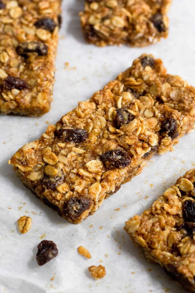Oatmeal protein bars spread out on a piece of parchment paper.