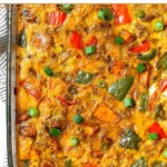 Overhead shot of a sweet potato breakfast casserole with sausage and peppers in a large glass casserole dish.