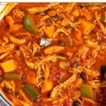 Chicken sweet potato soup with black beans and peppers in a large dutch oven.